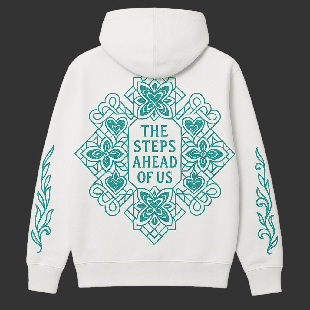 White hoodie with teal decorative patterns and text on a cream background.