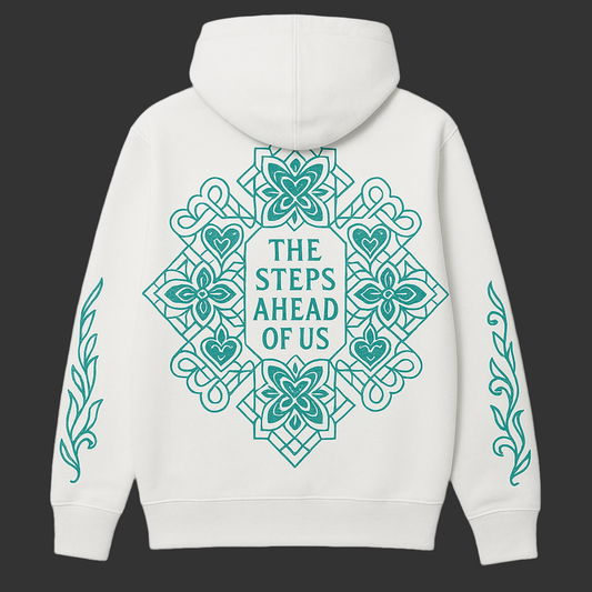 White hoodie with teal decorative patterns and text on a cream background.
