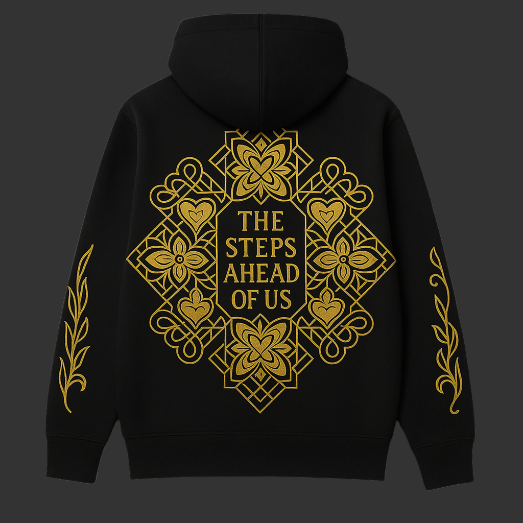 Black hoodie with gold geometric design and text on the back against a dark background